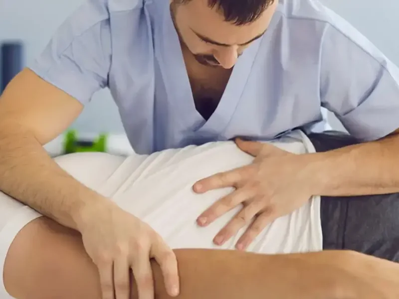 A therapist restoring a patient&rsquo;s movement by hand, the Prime phase of recovery
