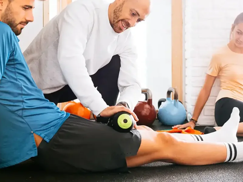 A patient loading a joint under a therapist&rsquo;s supervision, the Perform phase of recovery